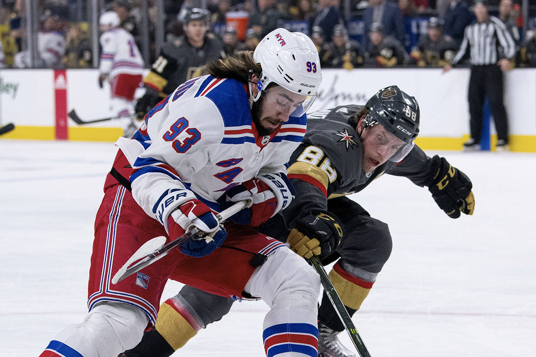 Vegas Golden Knights defenseman Nate Schmidt battles for the puck against New York Rangers center Mika Zibanejad during the first period of an NHL hockey game Tuesday, Jan. 8, 2019, in Las Vegas. ...