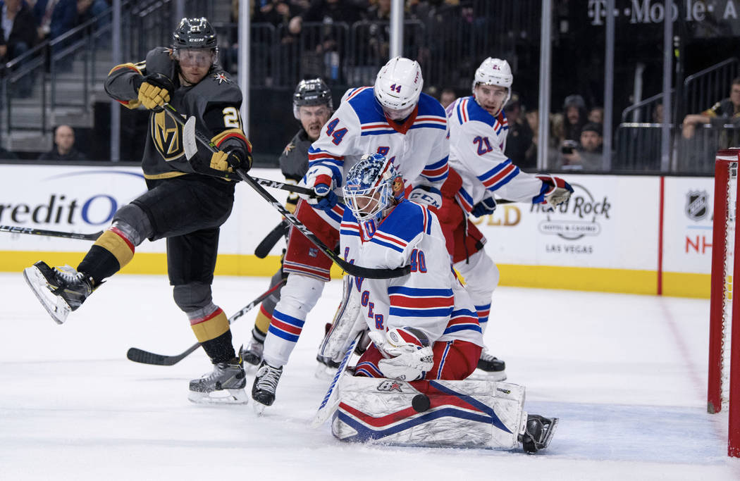 Vegas Golden Knights center Cody Eakin and New York Rangers defenseman Neal Pionk and goalie Alexandar Georgiev vie for the puck during the second period of an NHL hockey game Tuesday, Jan. 8, 201 ...