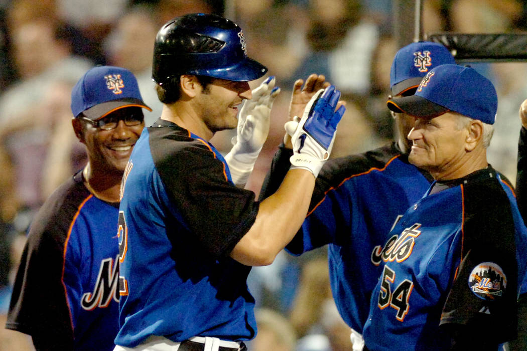 New York Mets' Xavier Nady, center is congratulated at the dugout by coaches including coach Rick Down (54) after hitting a third inning home run against the Washington Nationals during a spring t ...