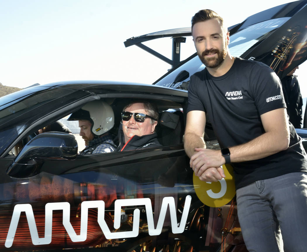 Former IndyCar driver Sam Schmidt, owner of Schmidt Peterson Motorsports, center, and IndyCar driver James Hinchcliffe, right, are shown as Schmidt prepares to take passenger Sean McGee, left, for ...