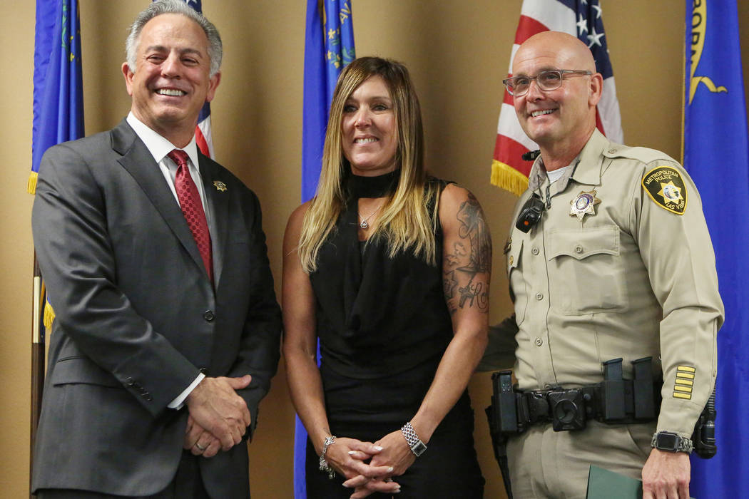 Officer Anthony Dellorso, right, stands next to Jody Ansell, center, whose life he saved during the Oct. 1, 2017, shooting as he is honored by Clark County Sheriff Joe Lombardo, left, with the Lif ...