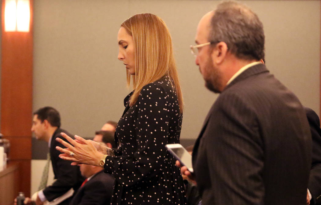 Attorney Alexis Plunkett, left, who prosecutors say bragged about putting a hit on her former boyfriend in prison, stands by her lawyer, Michael Becker prior to her court hearing at the Regional J ...