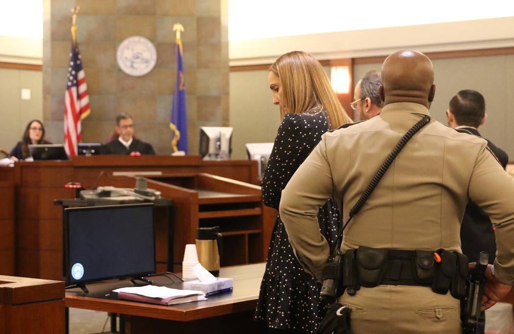 Attorney Alexis Plunkett, who prosecutors say bragged about putting a hit on her former boyfriend in prison, glances at a notepad during her court hearing at the Regional Justice Court in Las Vega ...