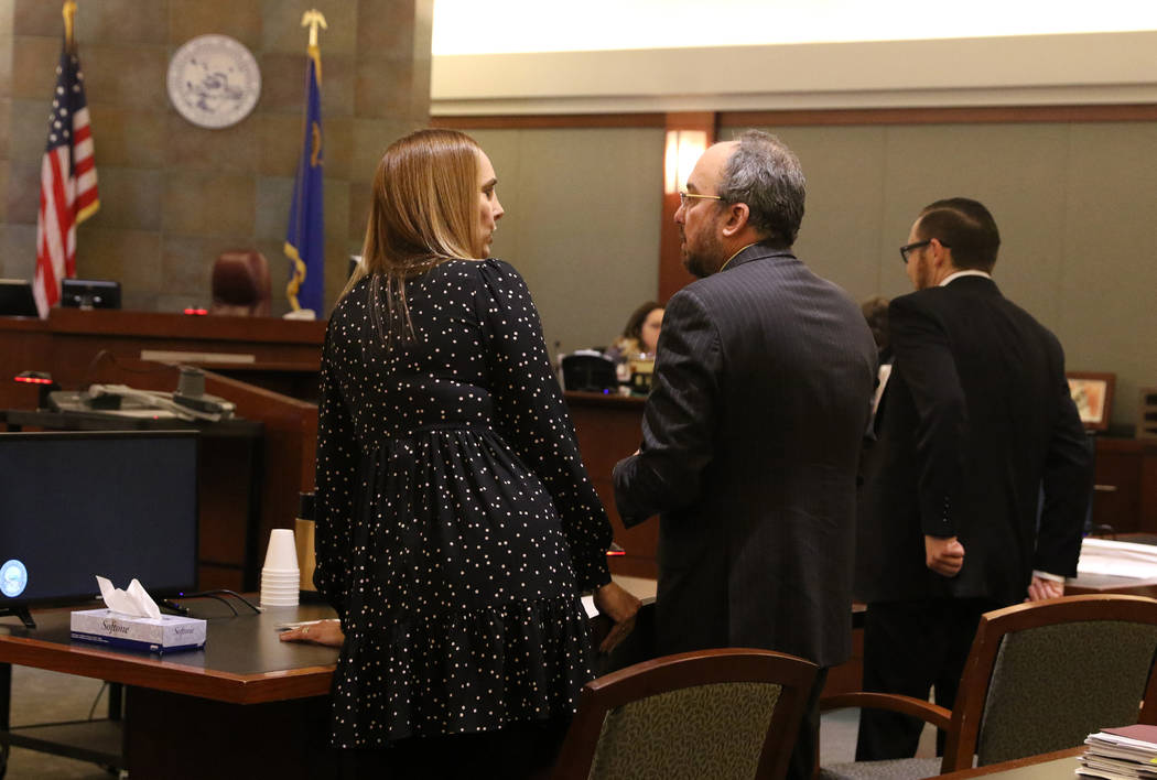 Attorney Alexis Plunkett, left, who prosecutors say bragged about putting a hit on her former boyfriend in prison, converses with her lawyers, Michael Becker, center, and Adam Solinger during her ...
