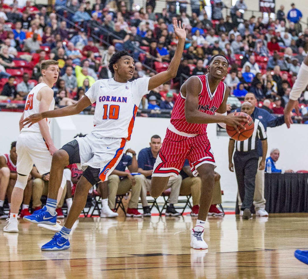 Findlay Prep's TJ Moss (1) looks to shoot as Bishop Gorman's Zaon Collins (10) looks to block him during the Big City Showdown at South Point in Las Vegas on Saturday, Jan. 20, 2018. Findlay Prep ...