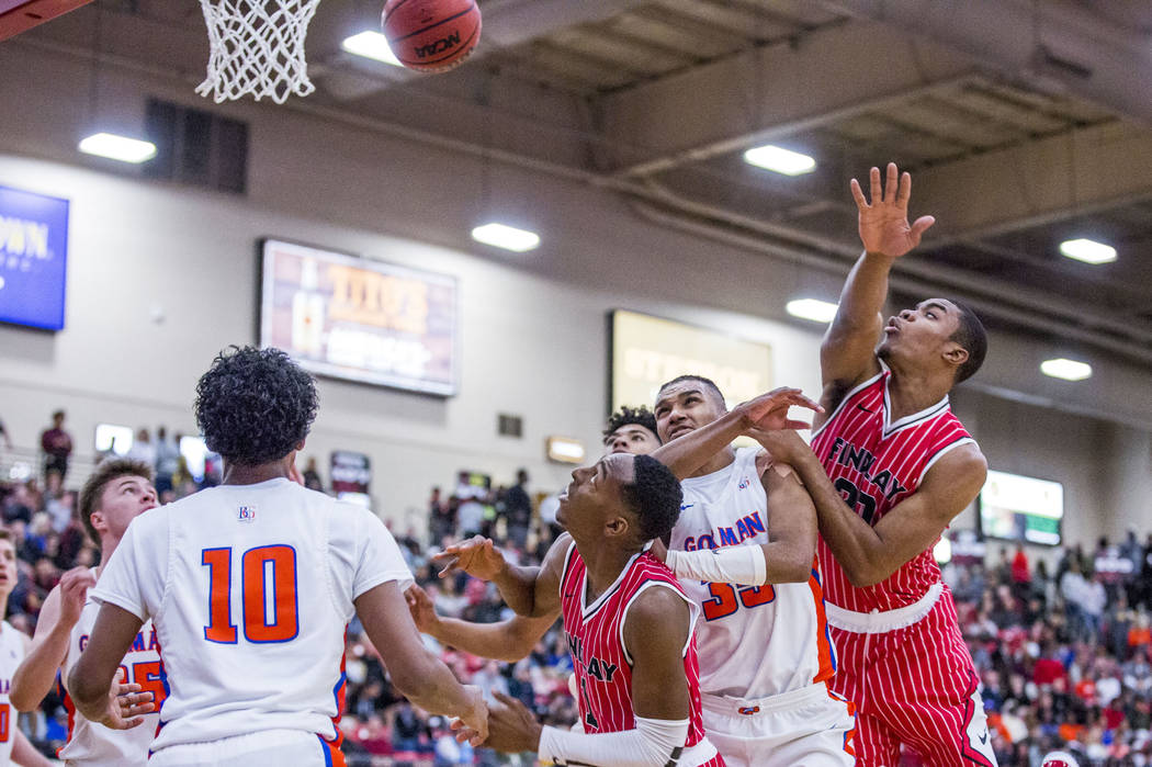 Findlay Prep's Reggie Chaney (20), right, loses control of the ball as Bishop Gorman's Zaon Collins (10) and Jamal Bey (35) look to get to the rebound while Findlay Prep's TJ Moss (1) watches the ...