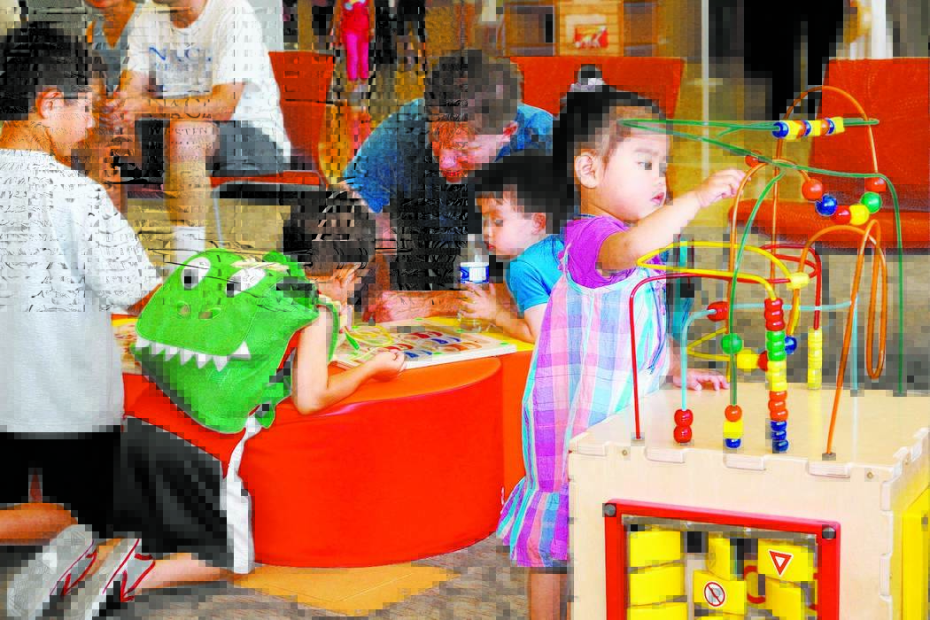 Children and adults play in the children's section at the Windmill Library, 7060 W. Windmill Lane, in Las Vegas. The library plans to offer a series of five Family Place Parent-Child Workshops for ...