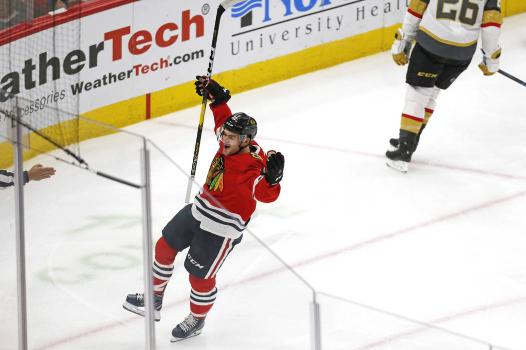 Chicago Blackhawks left wing Alex DeBrincat (12) celebrates after his goal against the Vegas Golden Knights, during the first period of an NHL hockey game Saturday, Jan. 12, 2019, in Chicago. (AP ...