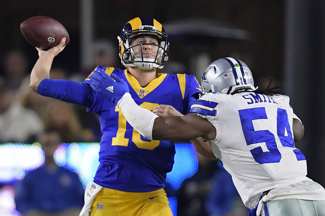 Los Angeles Rams quarterback Jared Goff passes under pressure from Dallas Cowboys middle linebacker Jaylon Smith during the first half in an NFL divisional football playoff game Saturday, Jan. 12, ...