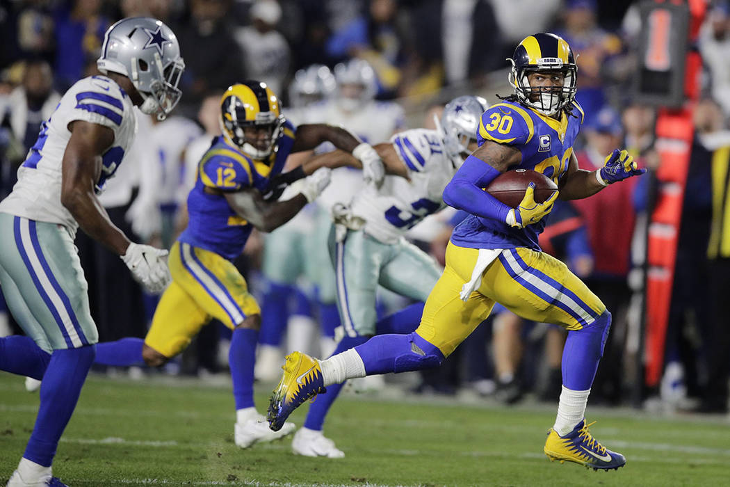 Los Angeles Rams running back Todd Gurley scores past Dallas Cowboys cornerback Chidobe Awuzie during the first half in an NFL divisional football playoff game Saturday, Jan. 12, 2019, in Los Ange ...