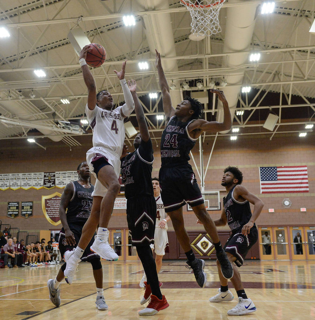 Faith Lutheran's Sedrick Hammond (4) goes to shoot the ball while under pressure from Cimarron Memorial's Tyrek Williams (32) and Isaiah Profit (24) during the second half of a basketball game at ...