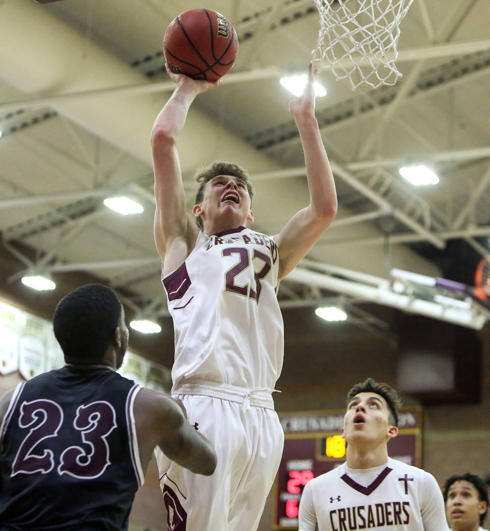Faith Lutheran's Brevin Walter (23) goes to shoot the ball while under pressure from Cimarron Memorial's JaiTwan Golden (23) during the first half of a basketball game at Faith Lutheran High Schoo ...