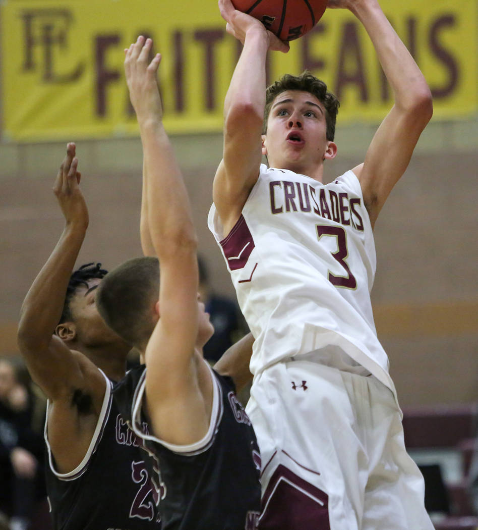 Faith Lutheran's Jason Sims (3) goes to shoot the ball while under pressure from Cimarron Memorial's Isaiah Profit (24) and Jacob Boelman (11) during the second half of a basketball game at Faith ...