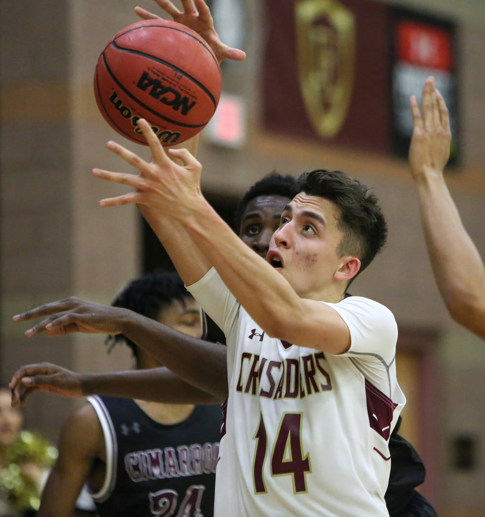 Faith Lutheran's Raymond Rosolino (14) goes to grab the ball while under pressure from Cimarron Memorial's Tyrek Williams (32) during the second half of a basketball game at Faith Lutheran High Sc ...