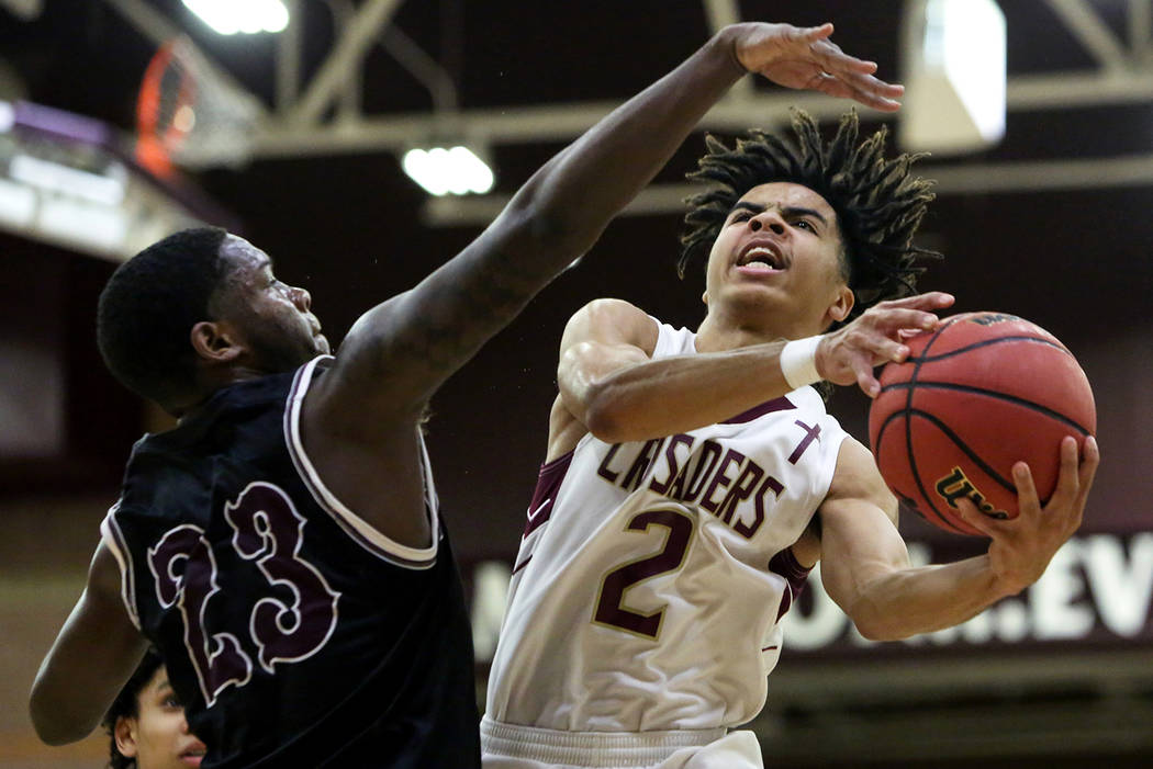 Faith Lutheran's Donavan Jackson (2) goes to shoot the ball while under pressure from Cimarron Memorial's JaiTwan Golden (23) during the first half of a basketball game at Faith Lutheran High Scho ...
