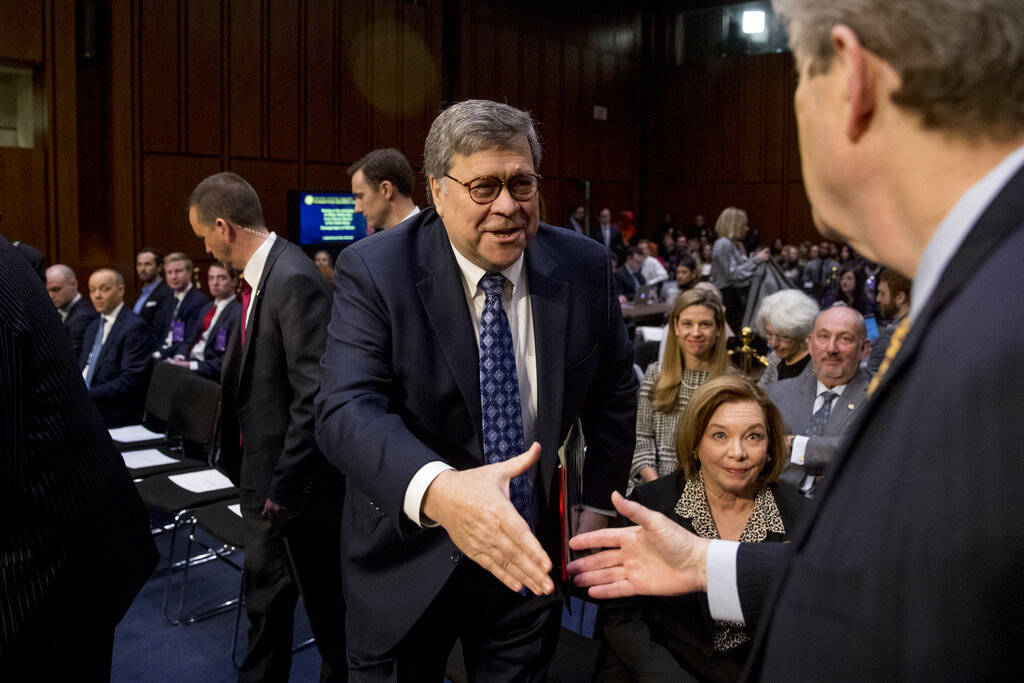 Attorney General nominee William Barr, center, shakes hands with Sen. John Kennedy, R-La., right, as he arrives to testify before the Senate Judiciary Committee on Capitol Hill in Washington, Tues ...