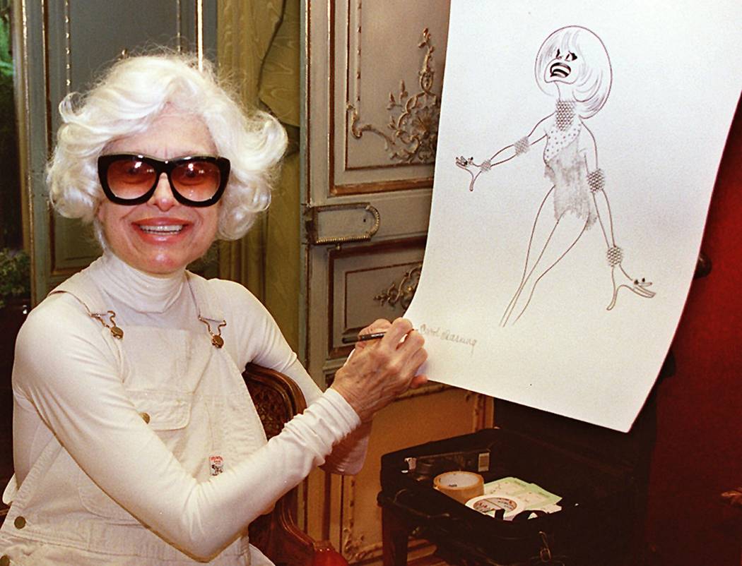 Actress Carol Channing signs a lithograph of herself by caricaturist Al Hirschfeld at her home in Beverly Hills, Calif., Nov. 1, 1997. Channing, whose career spanned decades on Broadway and on tel ...