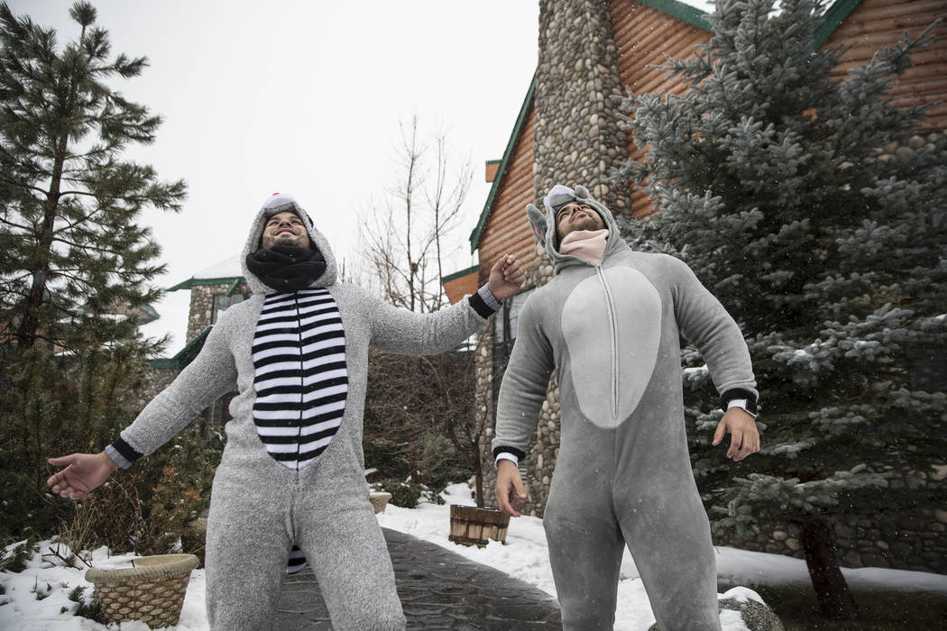 Erick Cano, left, and Yaser Moreno stay warm in their onesies as snow falls outside Mount Charleston Lodge on Tuesday, Jan. 15, 2019, in Las Vegas. Benjamin Hager Las Vegas Review-Journal