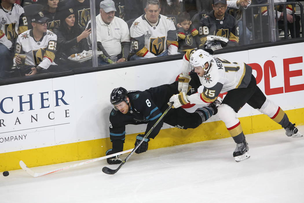 San Jose Sharks center Joe Pavelski (8) falls to the ice while as Vegas Golden Knights defenseman Jon Merrill (15) chases the puck during the first period of an NHL hockey game at T-Mobile Arena i ...