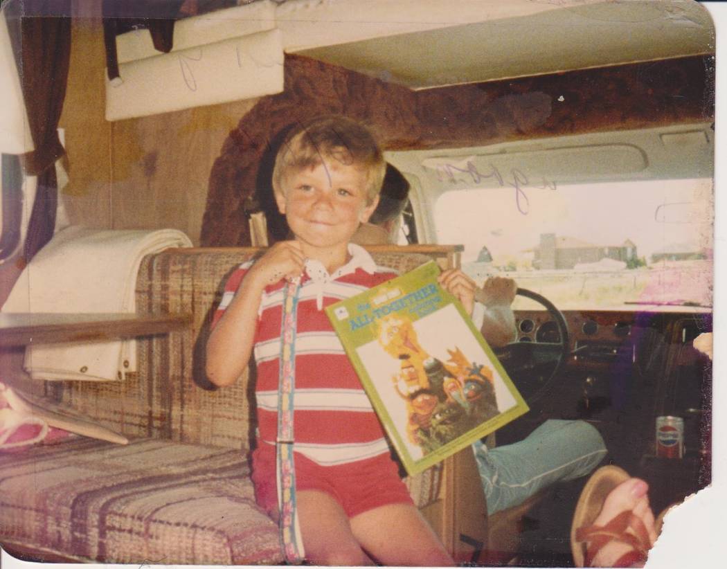 Michael Russell poses for a photo with his coloring book in an undated photo. (Russell family)