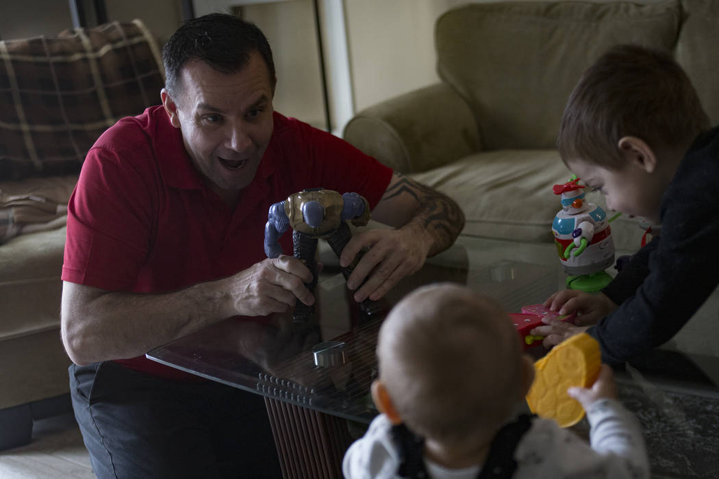 Michael Russell plays with his great nephew Cameron Gonzales, 2, and great niece Ava Gonzales, 11 months, at his home in Las Vegas, Friday, Jan. 11, 2019. When Michael was young, his father died, ...