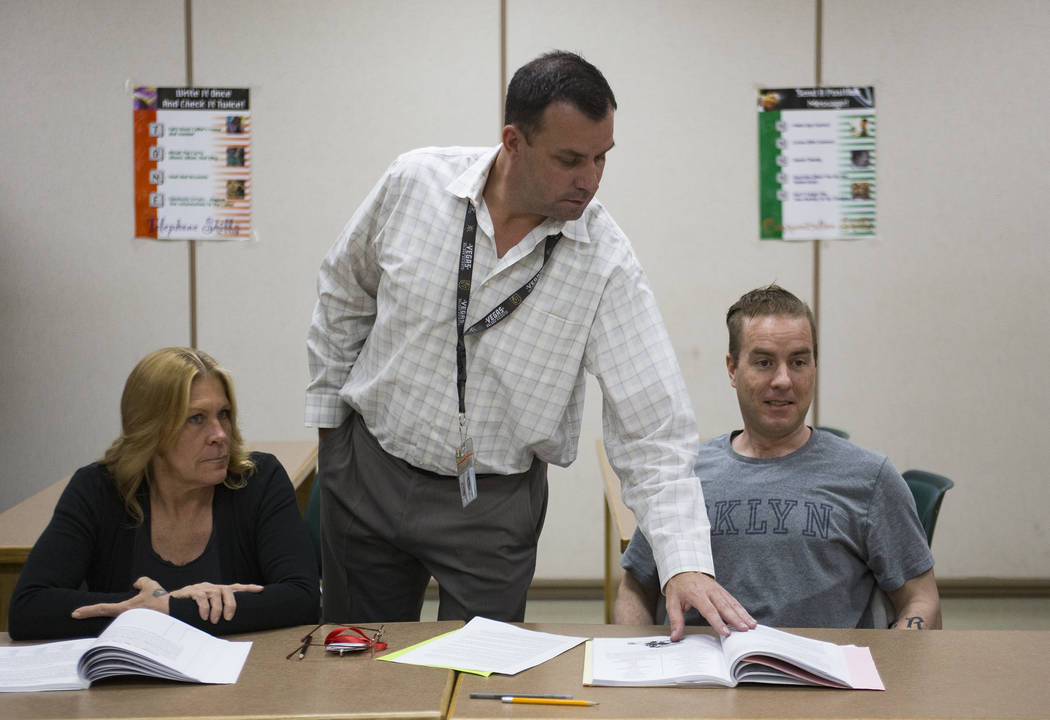 Michael Russell stands by inmates Carrie Kincaid and Andrew Morris as he leads a Moral Recognition Therapy class at Casa Grande, a transitional housing facility run by the Nevada Department of Cor ...