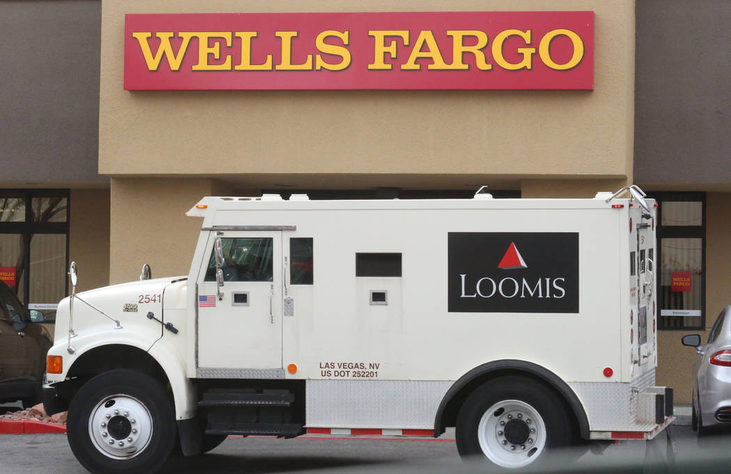 Loomis armored bank truck is parked outside a Wells Fargo branch