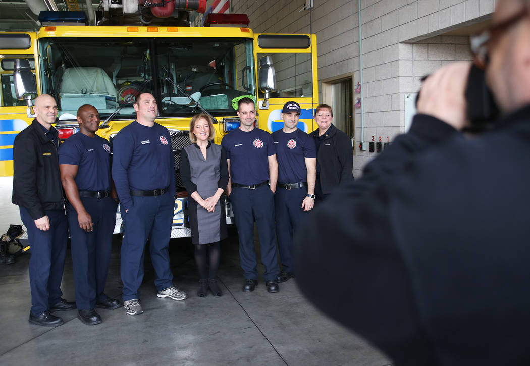 Chief Jeff Buchanan, from left, Captain Don Price, Firefighter Matt Leist, owner of Walker Furniture Linda Laterwitz-Mizrahi, Engineer Phil Robichaud, Firefighter Joe Fuscaldo, and Chief Kelly Bla ...