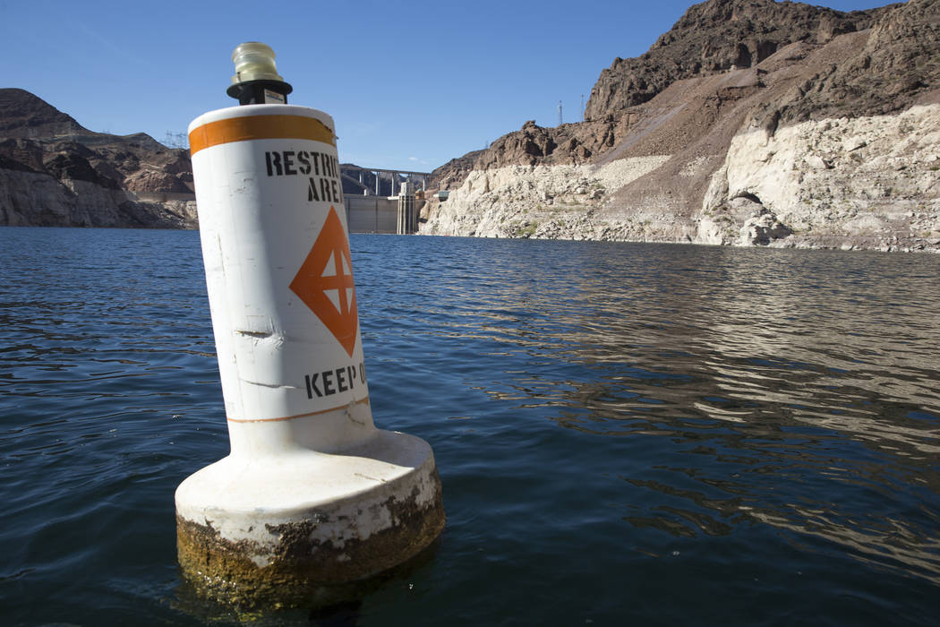 A buoy marks the restricted area to the Hoover Dam intake towers along the Colorado River's Black Canyon at Lake Mead National Recreation Area outside of Las Vegas on Wednesday, Oct. 17, 2018. (Ri ...