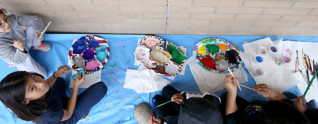 Students, including Adelyne Gomez, left, and Nathalie Ibarra-Lobato, second from left, paint magic wands during a Harry Potter-themed reading lesson in Kathryn Faulkner's fourth grade class at Tat ...