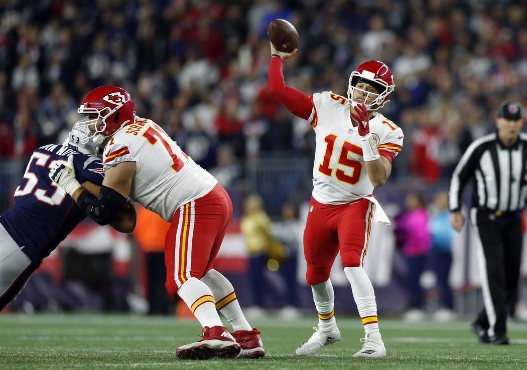 Kansas City Chiefs quarterback Patrick Mahomes (15) passes under pressure from New England Patriots linebacker Kyle Van Noy (53) during the first half of an NFL football game, Sunday, Oct. 14, 201 ...