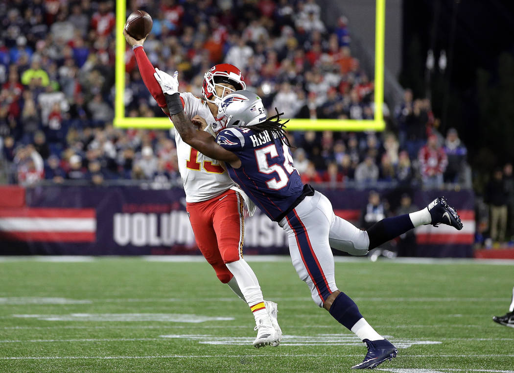 New England Patriots linebacker Dont'a Hightower (54) pressures Kansas City Chiefs quarterback Patrick Mahomes (15) as he tries to pass during the first half of an NFL football game, Sunday, Oct. ...