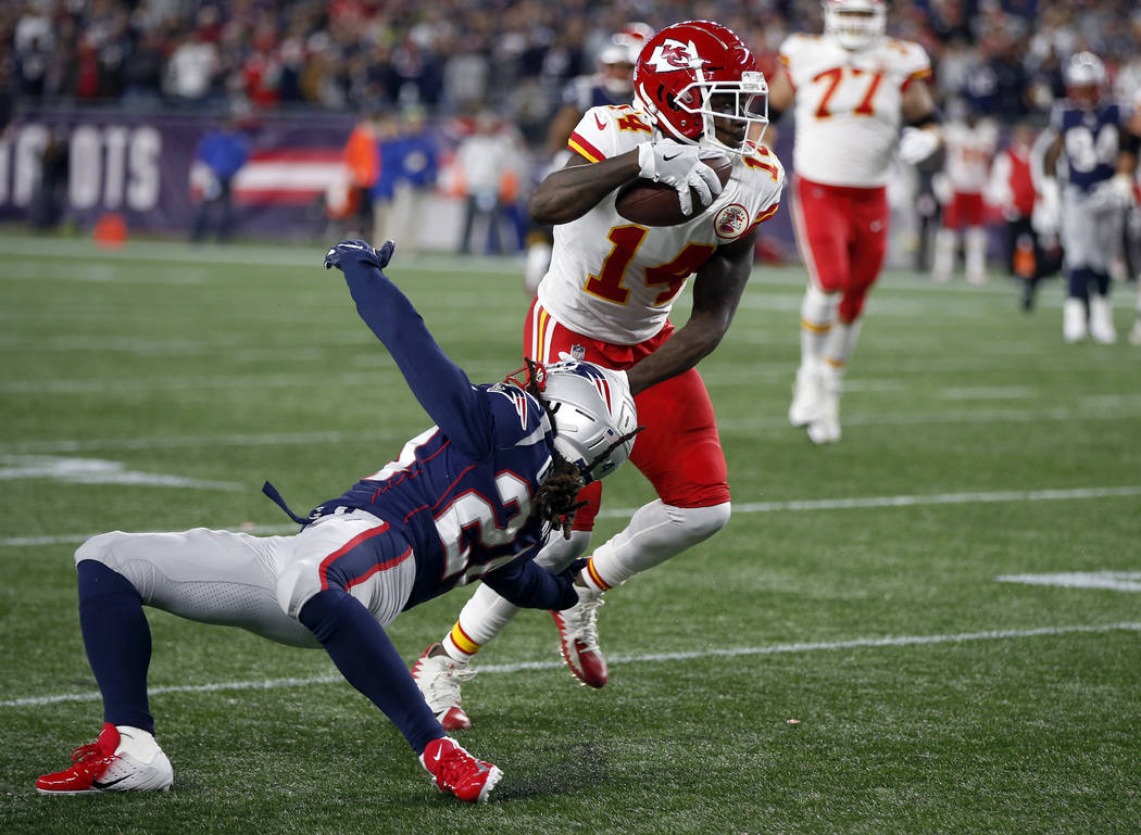 Kansas City Chiefs wide receiver Sammy Watkins (14) slips past New England Patriots defensive back Stephon Gilmore (24) after catching a pass during the second half of an NFL football game, Sunday ...