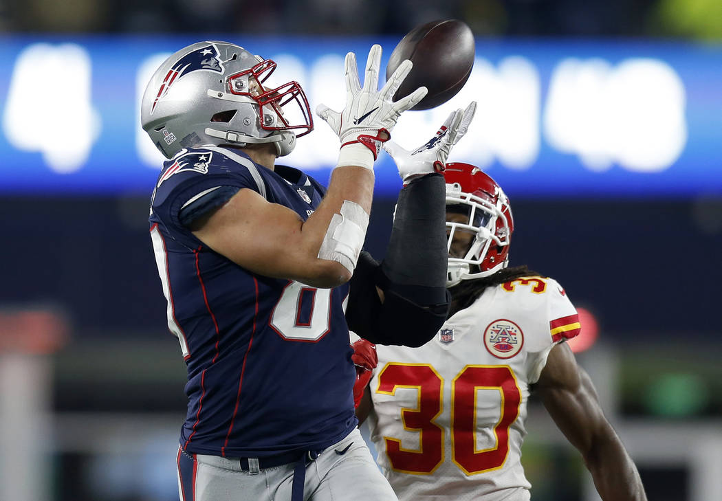FILE - In this Sunday, Oct. 14, 2018, file photo, New England Patriots tight end Rob Gronkowski, left, catches a pass in front of Kansas City Chiefs safety Josh Shaw (30) during the second half of ...