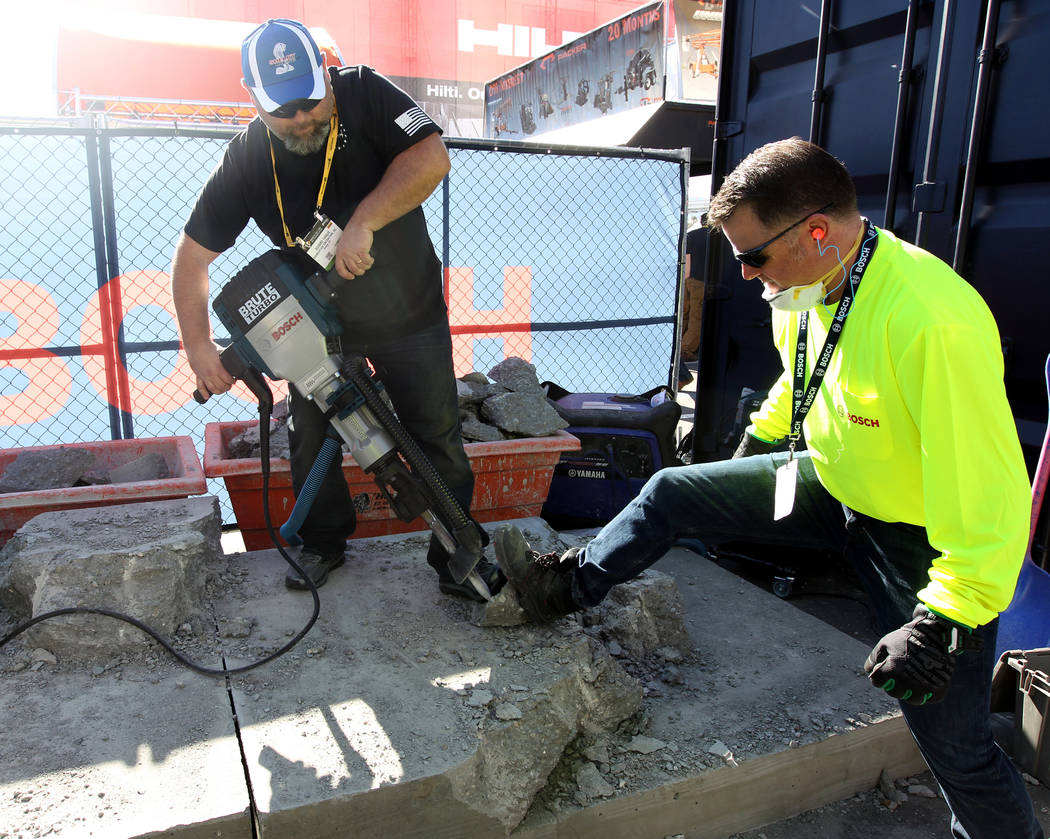 Richard Yargus of Kirkland, Wash. tries out a Brute Turbo jackhammer with Bosch representative Mats "Koah" Stgellnart of Mount Prospect, Ill. during the World of Concrete show at the Las ...