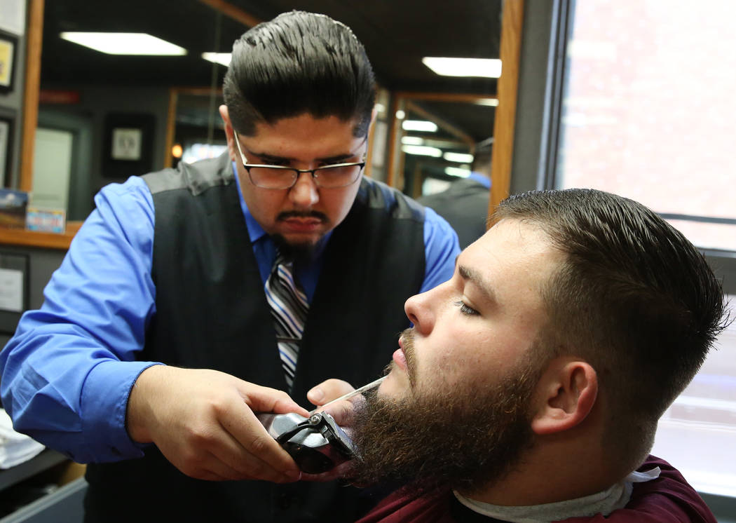 Barber Andres Dominguez trims Kyle Lamb's beard at his Speakeasy Barbershop LV at El Cortez hotel-casino on Saturday, Jan. 19, 2019, in Las Vegas. Bizuayehu Tesfaye/Las Vegas Review-Journal @bizut ...