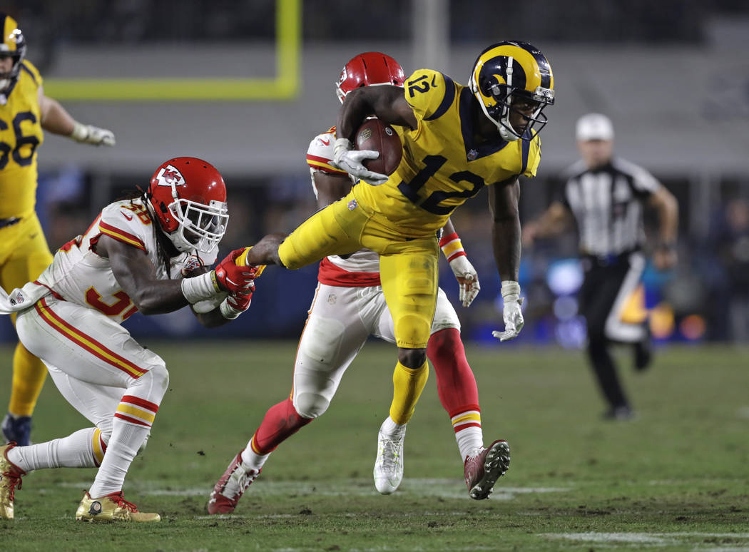 Los Angeles Rams wide receiver Brandin Cooks (12) is tripped up by Kansas City Chiefs free safety Ron Parker, left, during the second half of an NFL football game, Monday, Nov. 19, 2018, in Los An ...