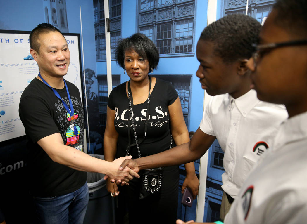 Zappos CEO Tony Hsieh, left, meets Malik McHugh, 14, second from right, and Marshon Lee, 14, both eighth graders at Rainbow Dreams Academy, as organizer Duana Malone looks on during the first Dr. ...