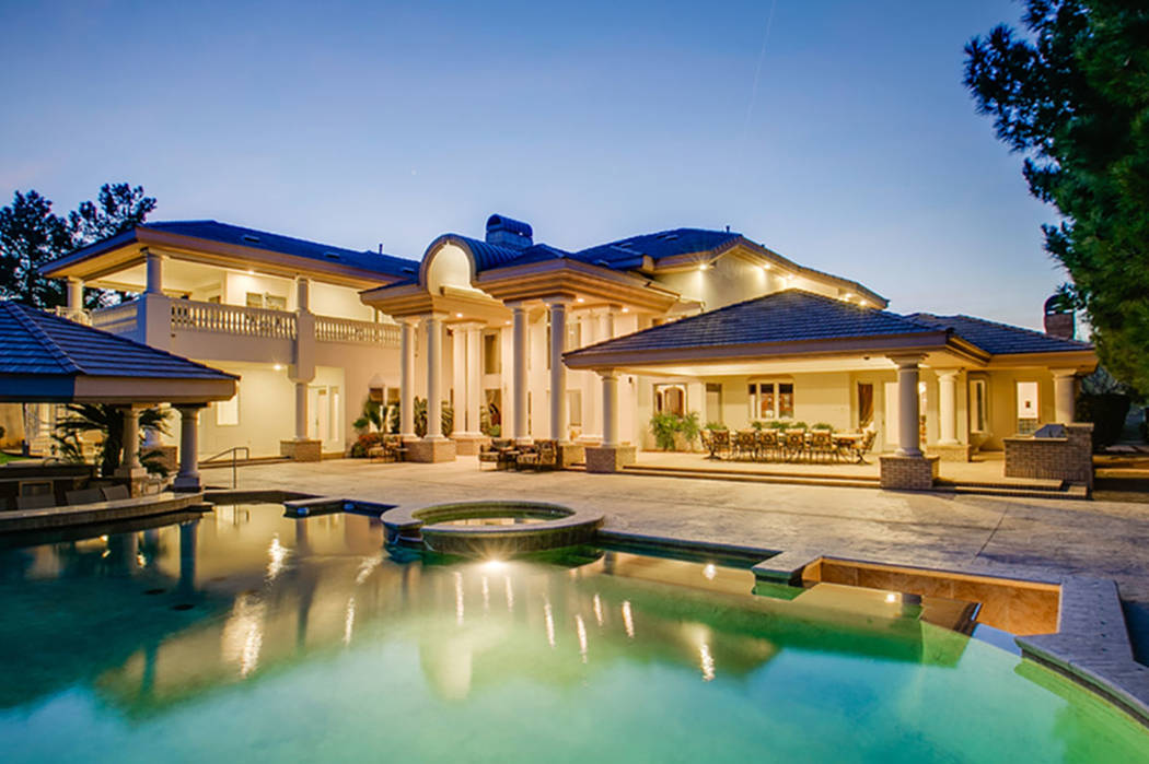 The backyard of the mansion at 9009 Greensboro Lane in Las Vegas is seen above. The home was formerly owned by Edwin Fujinaga, who was convicted in November of running a $1.5 billion Ponzi scheme. ...