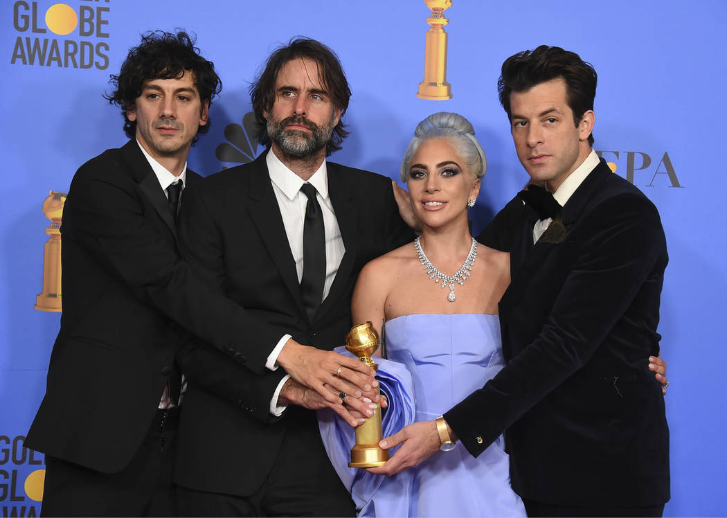 Anthony Rossomando, from left, Andrew Wyatt, Lady Gaga and Mark Ronson pose in the press room with the award for best original song, motion picture for "Shallow" from the film "A St ...