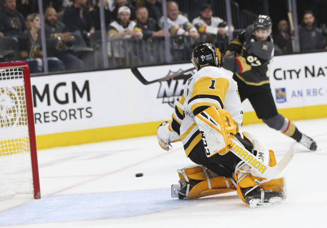 Pittsburgh Penguins goaltender Casey DeSmith (1) gives up a goal to Golden Knights left wing Max Pacioretty, background right, during the first period of an NHL hockey game at T-Mobile Arena in La ...