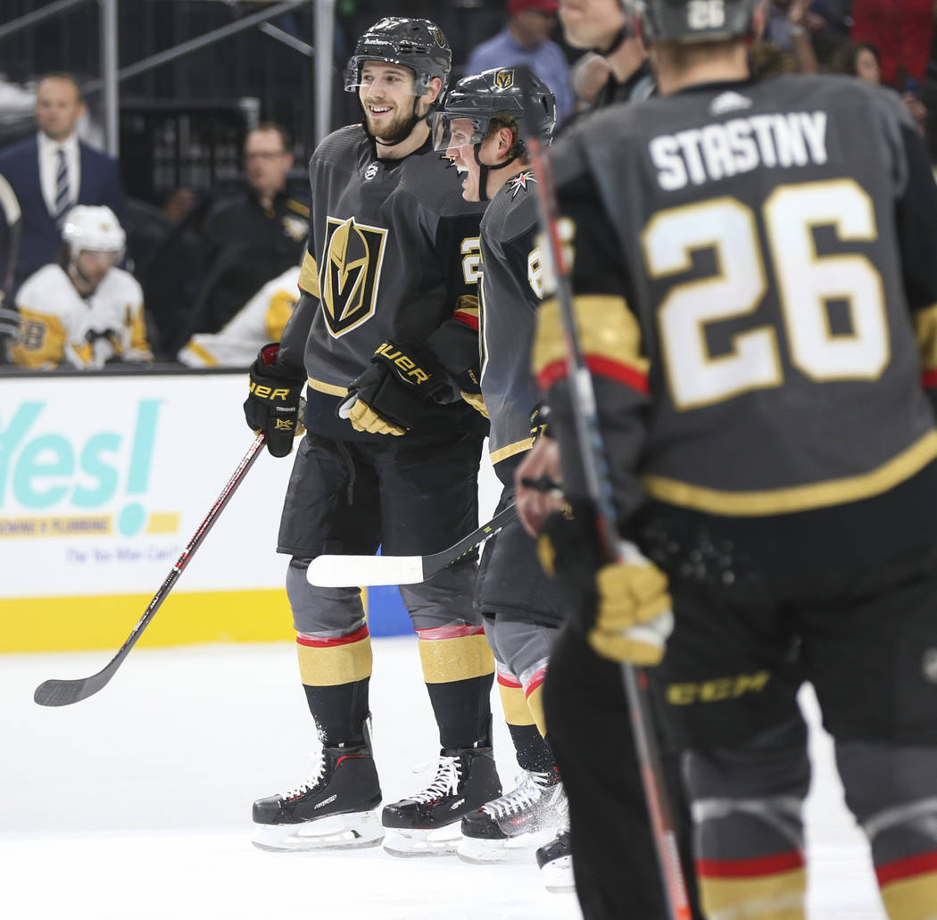 Golden Knights defenseman Shea Theodore, left, celebrates his goal with Golden Knights defenseman Nate Schmidt during the first period of an NHL hockey game against the Pittsburgh Penguins at T-Mo ...