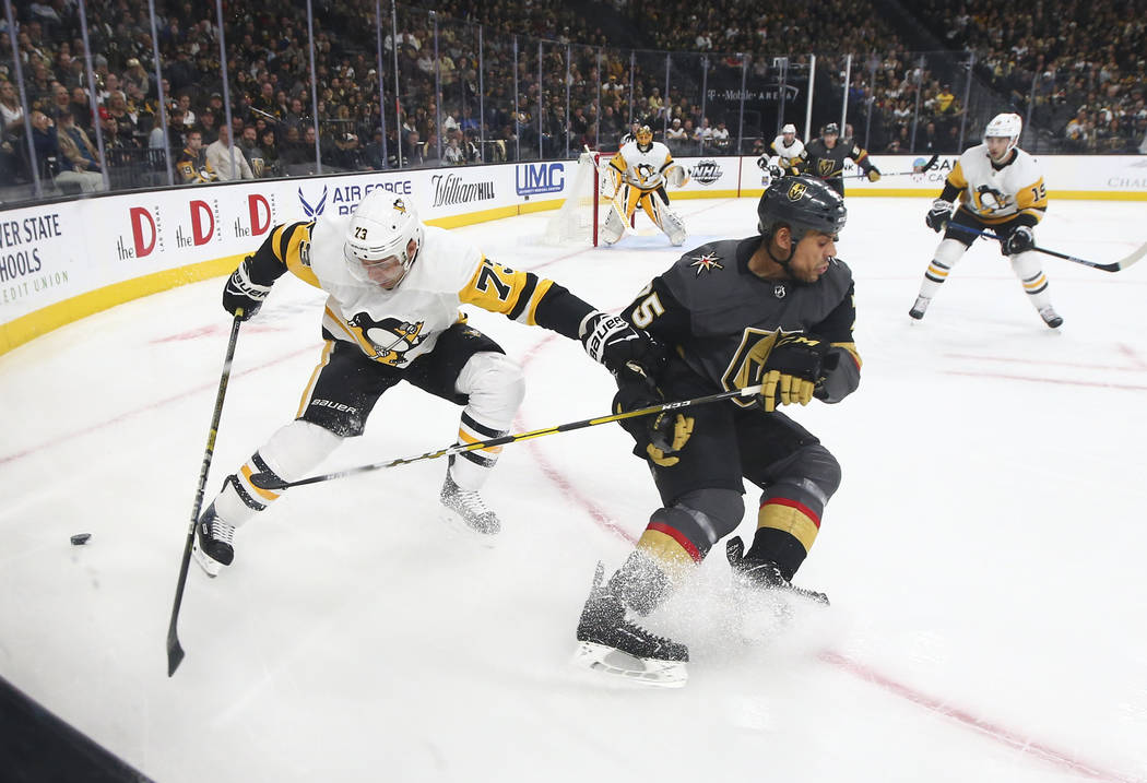 Golden Knights right wing Ryan Reaves (75) battles for the puck against Pittsburgh Penguins defenseman Jack Johnson (73) during the first period of an NHL hockey game at T-Mobile Arena in Las Vega ...
