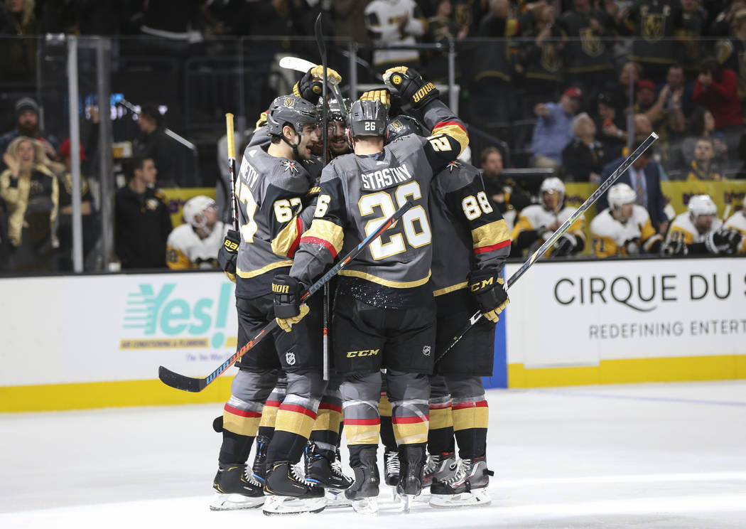 Golden Knights players celebrate a goal by defenseman Shea Theodore during the first period of an NHL hockey game against the Pittsburgh Penguins at T-Mobile Arena in Las Vegas on Saturday, Jan. 1 ...