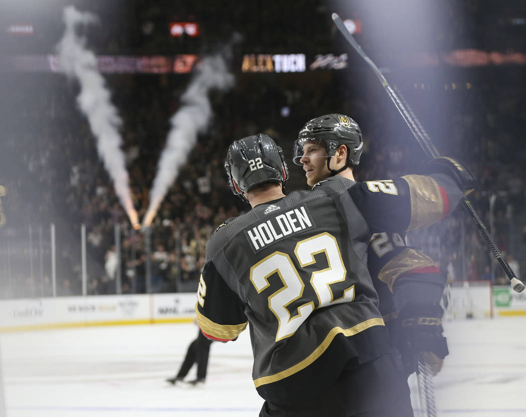 Golden Knights defenseman Nick Holden (22) celebrates a goal by center Oscar Lindberg during the first period of an NHL hockey game against the Pittsburgh Penguins at T-Mobile Arena in Las Vegas ...