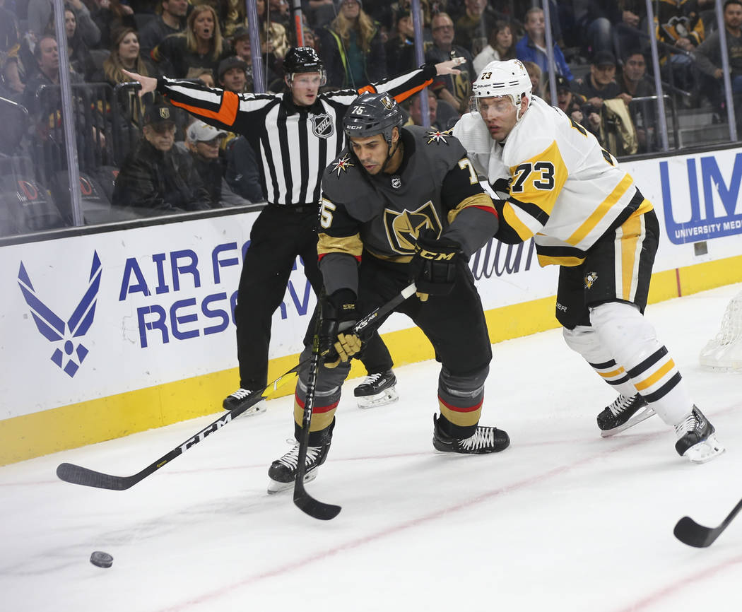 Golden Knights right wing Ryan Reaves (75) and Pittsburgh Penguins defenseman Jack Johnson (73) battle for the puck during the first period of an NHL hockey game at T-Mobile Arena in Las Vegas on ...