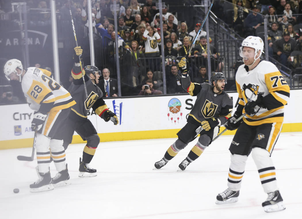 Golden Knights players Jonathan Marchessault, left, and Brandon Pirri celebrate a goal by William Karlsson, not pictured, during the third period of an NHL hockey game against the Pittsburgh Pengu ...