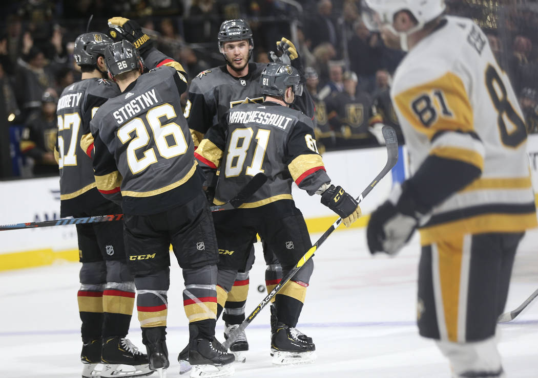 Golden Knights players celebrate a goal by center Jonathan Marchessault (81) during the third period of an NHL hockey game against the Pittsburgh Penguins at T-Mobile Arena in Las Vegas on Saturda ...