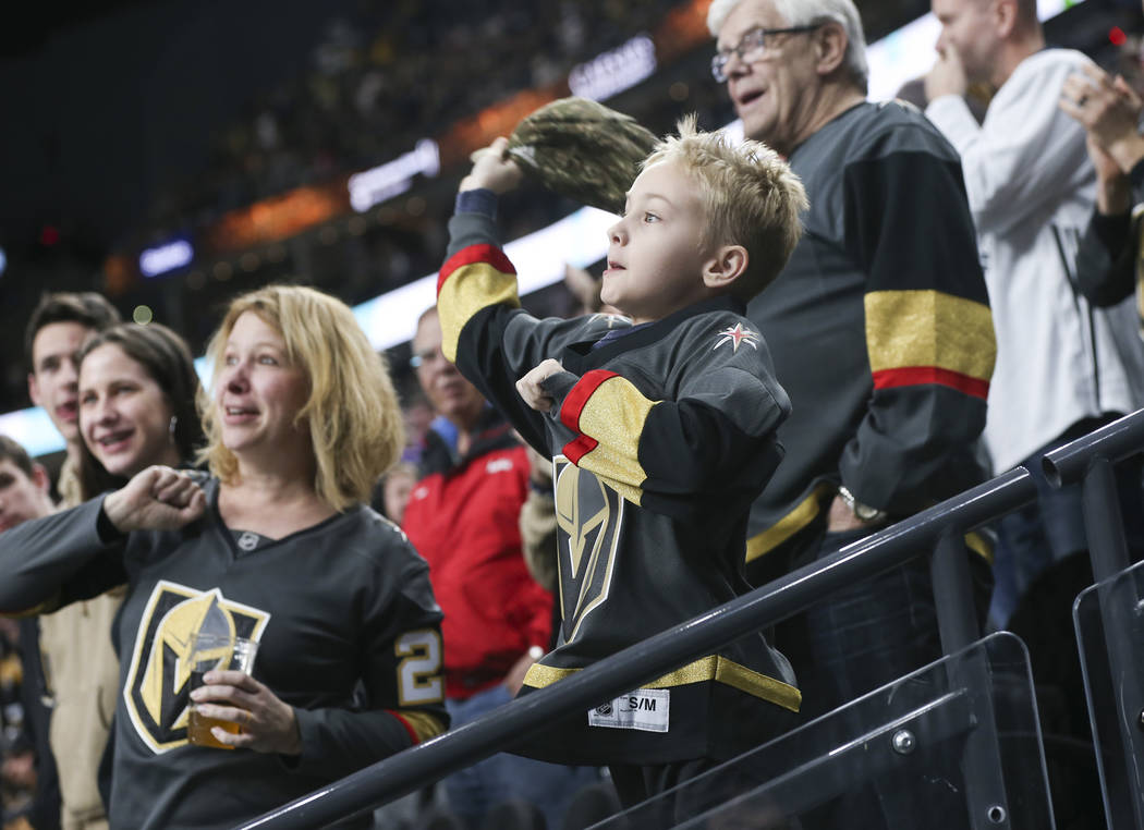 Golden Knights fans throw their hats onto the ice in celebration of a hat trick by Jonathan Marchessault, not pictured, during the third period of an NHL hockey game against the Pittsburgh Penguin ...