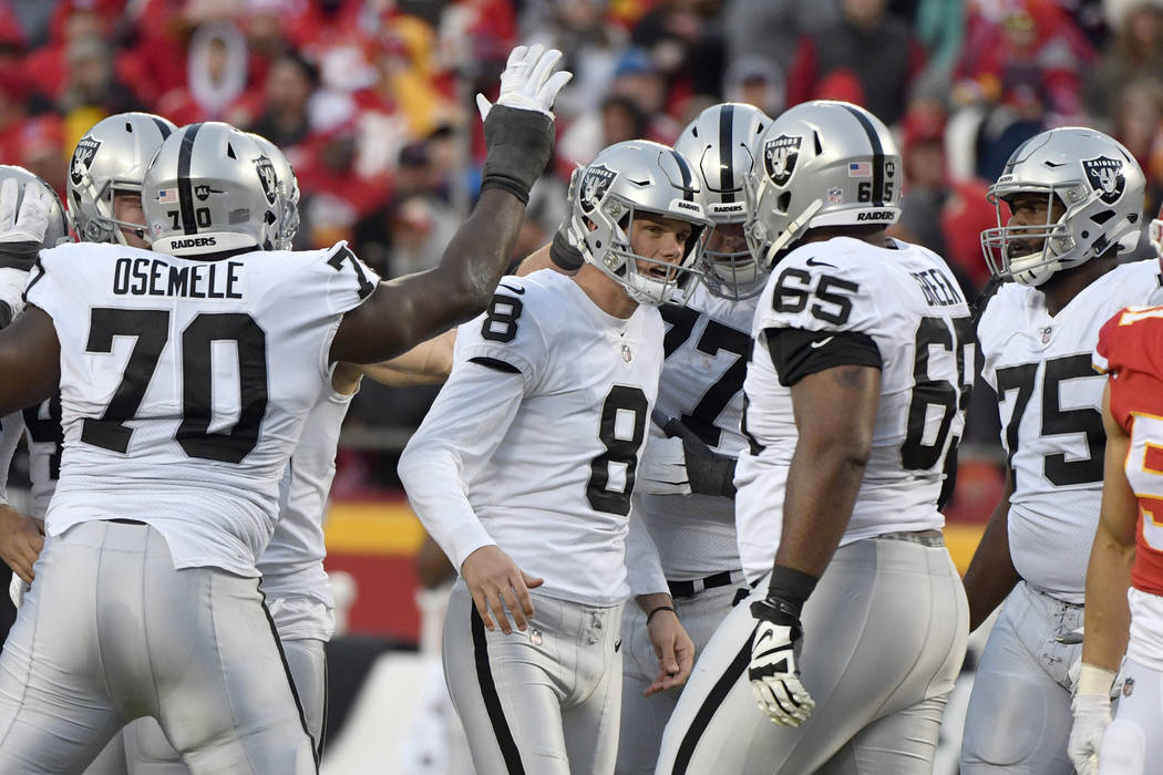 Oakland Raiders kicker Daniel Carlson (8) is congratulated by teammates after he kicked a field goal against the Kansas City Chiefs in Kansas City, Mo., Sunday, Dec. 30, 2018. With the Raiders mov ...